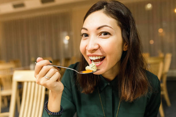 istock Young woman eating in the restaurant 1146067043