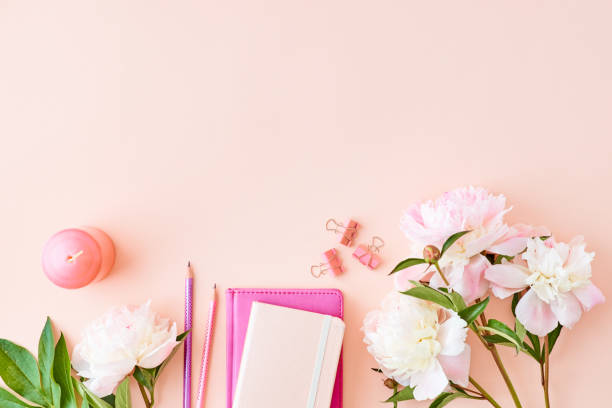 istock Blogger or freelancer workspace with notebook and light pink peonies on a pink background 1146069265