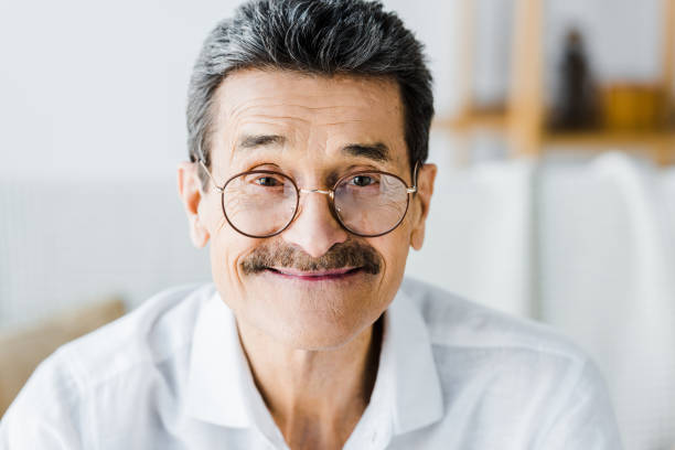 istock happy senior man in glasses smiling at home 1146070818