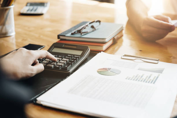 istock Business or Accountant people using calculator and laptop computer for discussion about profit, tax, financial 1146071896