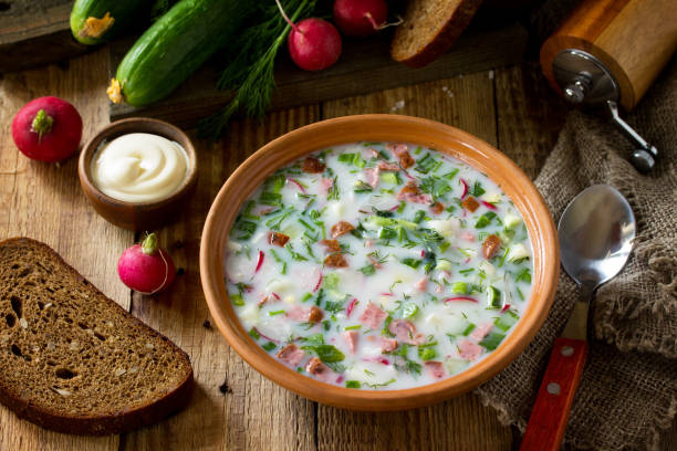 istock Delicious summer lunch. Spring-summer yoghurt cold soup  fresh vegetables and kefir on rustic wooden table. 1146072075