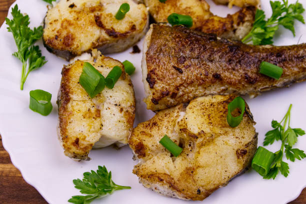istock Roasted pollock in white plate on a wooden table 1146074166
