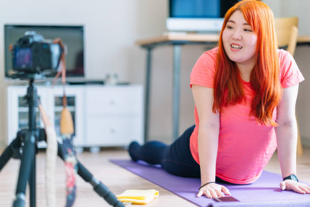 istock Young woman vlogging her yoga routine 1146074291