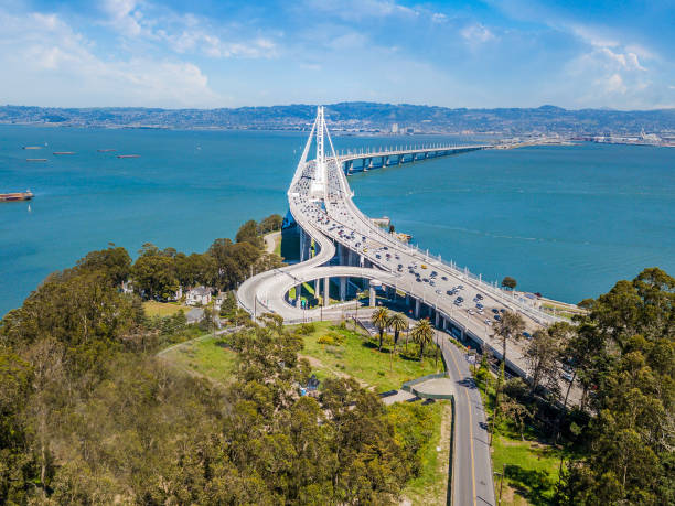 Aerial View of Bay Bridge An aerial view of the Bay Bridge on a sunny day. A view from Treasure Island looking across the bay at Emeryville and Oakland. Ships and boats are in the Bay. alameda county stock pictures, royalty-free photos & images