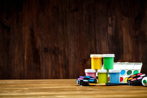 close-up of watercolor paint sets and paintbrushes on desk with copy space - artists canvas yellow white red imagens e fotografias de stock