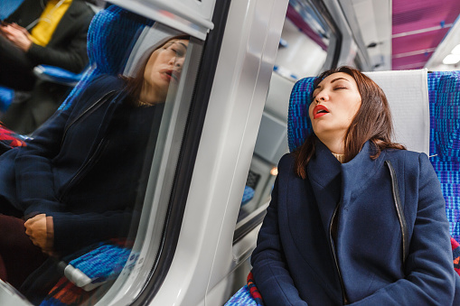 Traveler woman funny sleeping in a train