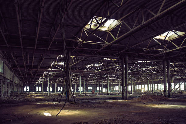 istock Abandoned large industrial hall or warehouse with garbage, ruined factory 1146079507