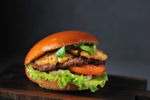 hamburger with cutlet, tomato and pineapple