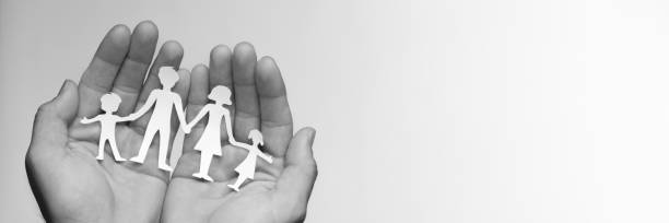 istock Hands Holding Paper Family 1146081802
