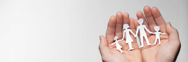 istock Hands Holding Paper Family 1146081807