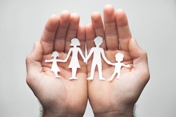 istock Hands Holding Paper Family 1146081935