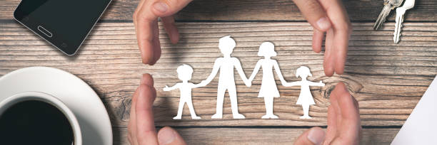 istock Hands Surrounding Paper Family 1146081972