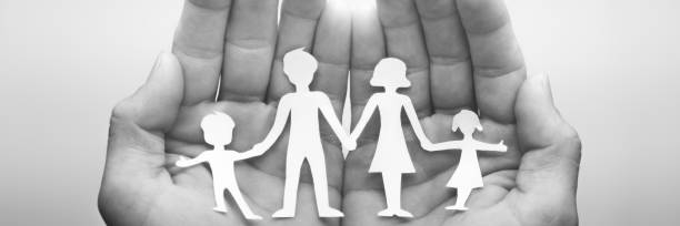 istock Hands Holding Paper Family 1146082098