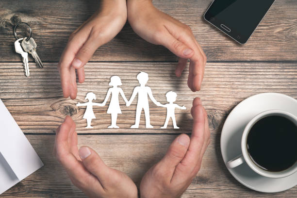 Hands Surrounding Paper Family