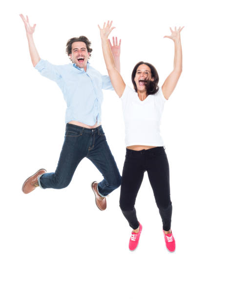 istock Attractive couple jumping for joy 1146085692