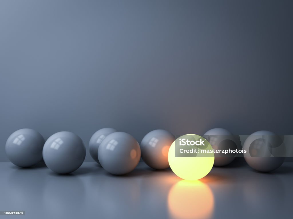 Stand out from the crowd and Leadership creative idea concepts One luminous sphere shining among other dim spheres on white background in the dark with reflections and shadows 3D rendering Individuality Stock Photo