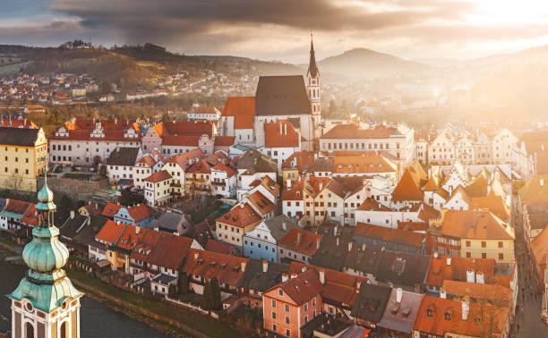 istock DECEMBER 2017, CESKY KRUMLOV, CZECH REPUBLIC: beautiful aerial panoramic view during sunset from the tower of the houses, castle and church in the medieval European town 1146094074