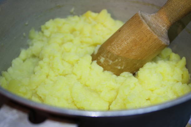 istock mashed potatoes in a pan with a wooden pestle 1146096277