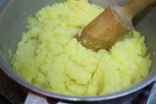istock mashed potatoes in a pan with a wooden pestle 1146096280