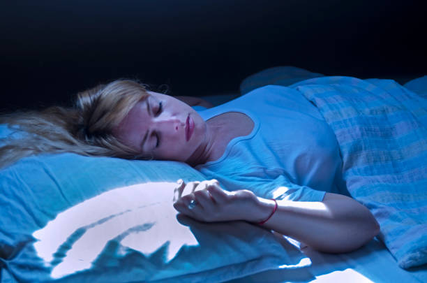 istock Woman sleeping in bed at fool moon light. 1146096629
