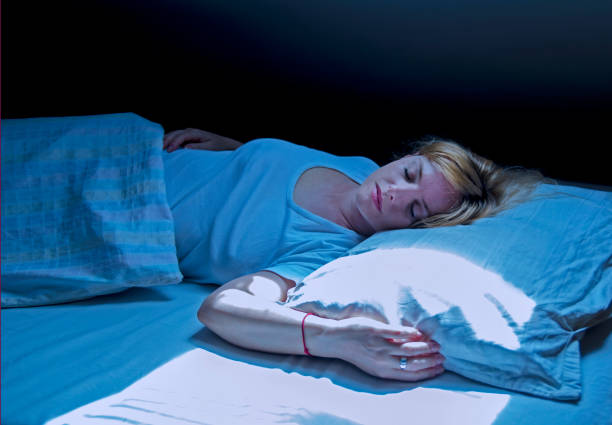 istock Woman sleeping in bed at fool moon light. 1146096869