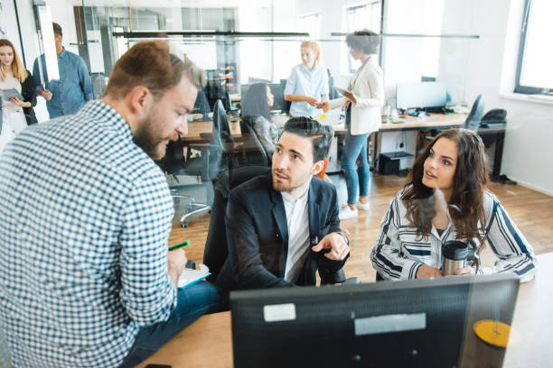 istock Three colleagues talking about their new business plan in the office 1146098091
