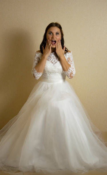 istock Bride in a wedding dress with a red flower 1146100607