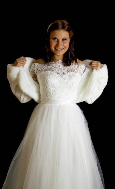 istock Bride in a wedding dress with a red flower 1146100811