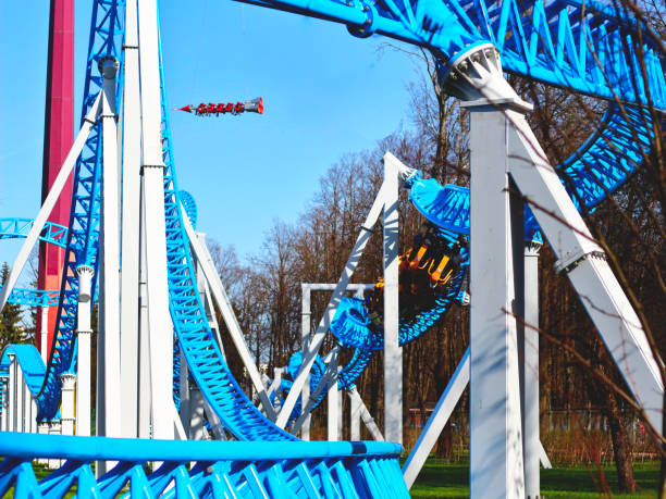 istock Blue roller coaster with a loop and a bend in an amusement park against a blue sky 1146102975