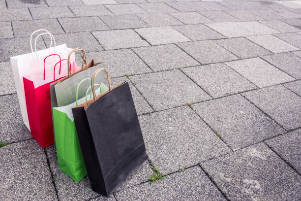 istock Paper shopping bags on pavement 1146105292