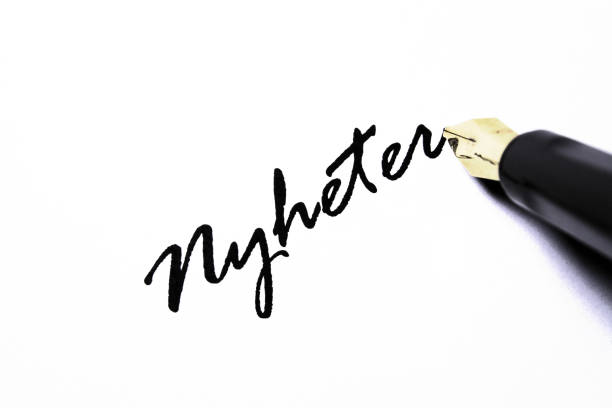 Ink spills on a clean white background.  Old fashioned ink bottle and quill pen.  Back to school. 