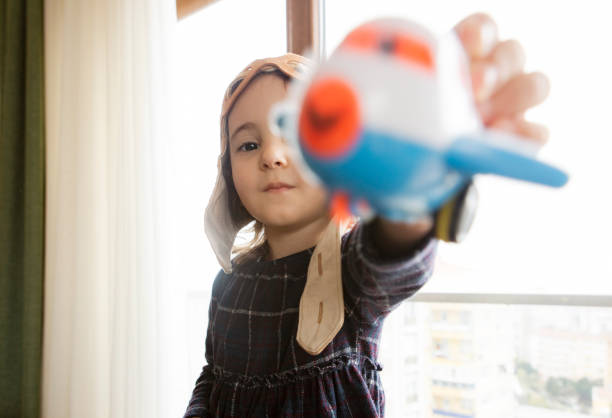 istock Girl playing with toy airplane 1146106786