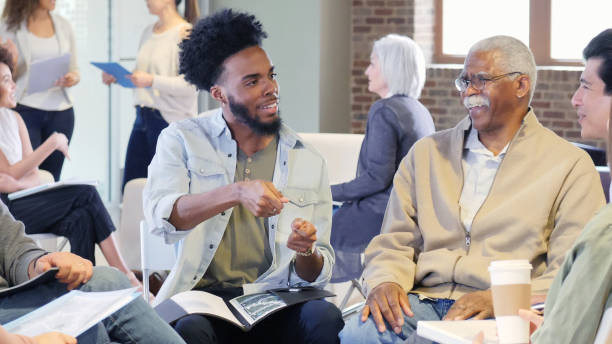 istock Mid adult man explains community project 1146106897