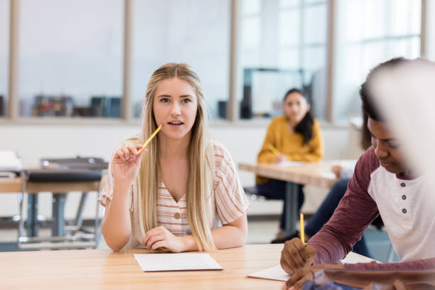 istock Teen girl takes notes on exciting class topic 1146107058