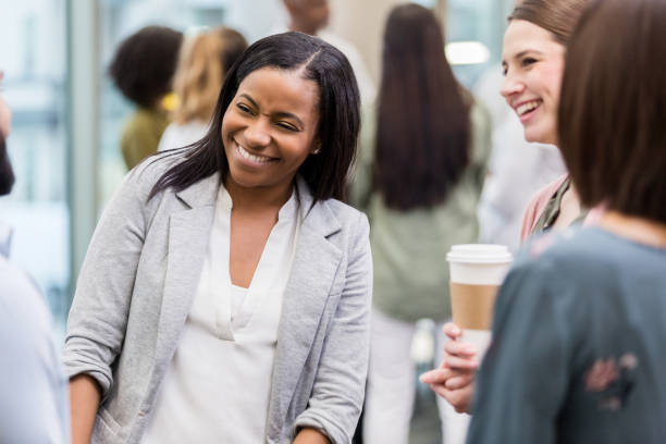 istock Two women enjoy conversation with an unidentified man 1146107208