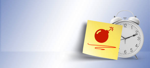 bomb symbol on blue sticky note paper attached on white alarm clock with large copy space