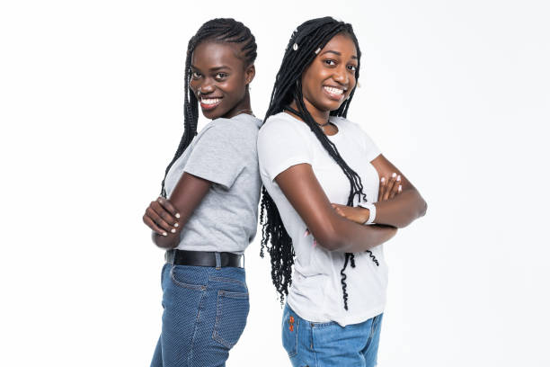 istock Two african woman standing back to back isolated on white background 1146107980