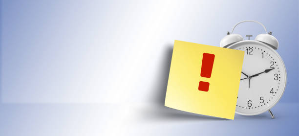istock as a reminder, exclamation  symbol on yellow sticky note paper with white alarm clock 1146108001