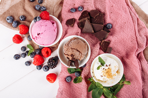 Chocolate Strawberry Vanilla Icecream Set Flat Lay. Three Different Ice Cream Dessert in Cup Top Down View. Brown White and Pink Gelato Color Mix. Variety Flavors Set of Soft Frozen Creamy Snack