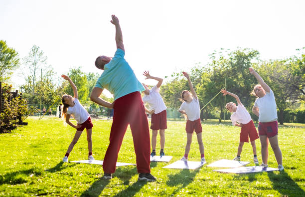 istock Group of children exercising in nature 1146112629