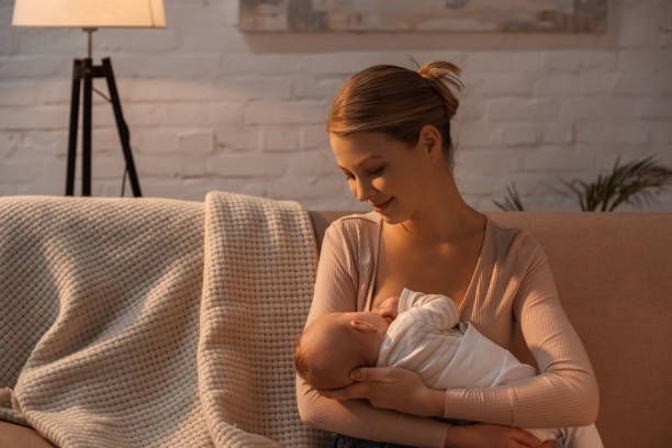 istock smiling young mother breastfeeding baby at night 1146115544