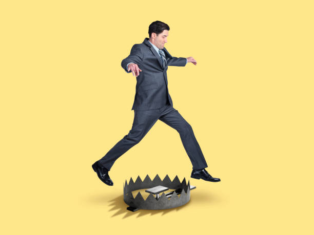 istock Businessman Jumps Over A Trap 1146116699