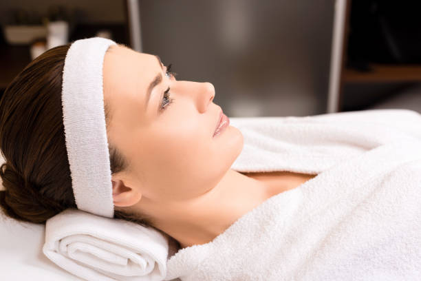 istock woman lying in white bathrobe at beauty salon 1146116992