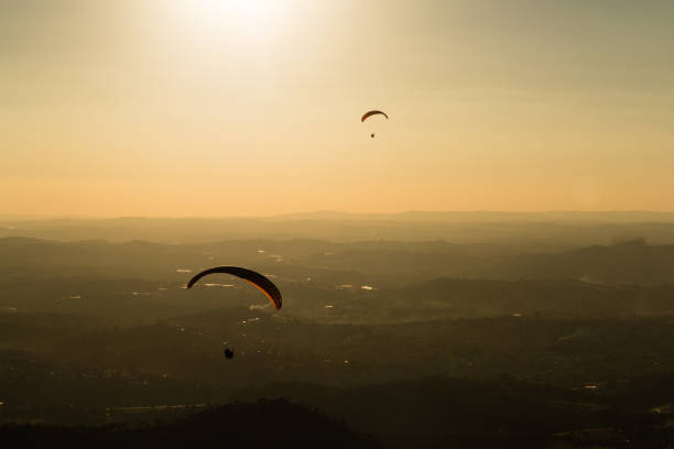 Two men soaring in a tandem paragliding flight