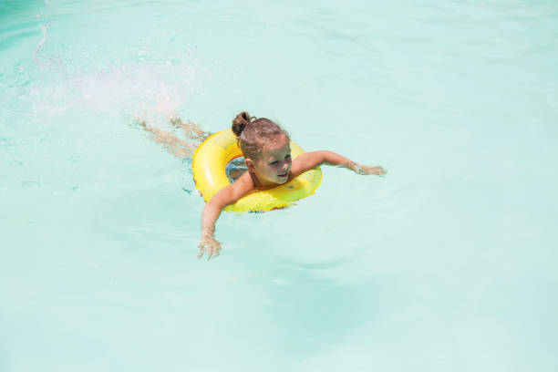 istock Baby boy is swimming in the pool 1146119925