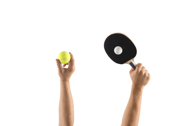 Ping pong ball and rackets on yellow background