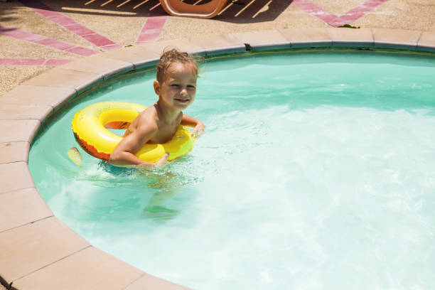 istock Baby boy is swimming in the pool 1146120211