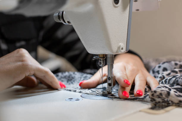istock close-up seamstress hand stitches fabric on the sewing machine 1146121597