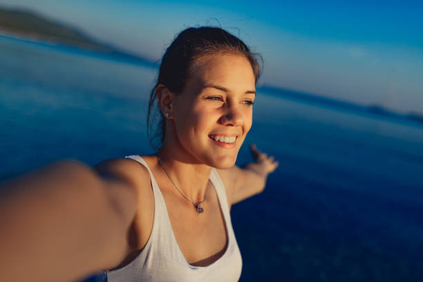 istock Young woman enjoying on beach at dusk 1146123348