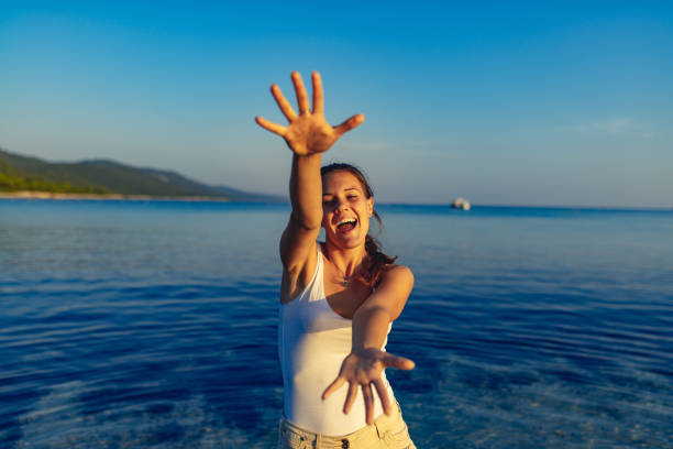 Young woman enjoying on beach at dusk